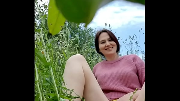 Naked horny MILF in a chamomile field masturbat...
