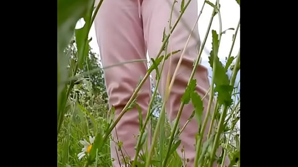 Naked horny MILF in a chamomile field masturbates, pisses and wards off a wasp / Angela-MILF