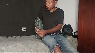 A handsome dark-haired man with ebony skin masturbating.