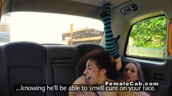 Female fake taxi driver with ebony babe in backseat
