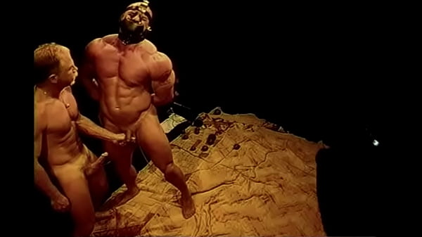 Squeezing huge bodybuilder's balls.