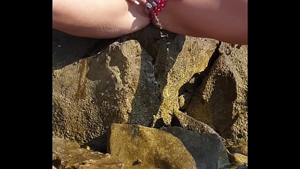 Nina Black peeing by the sea