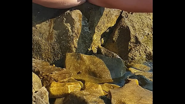 Nina Black peeing by the sea