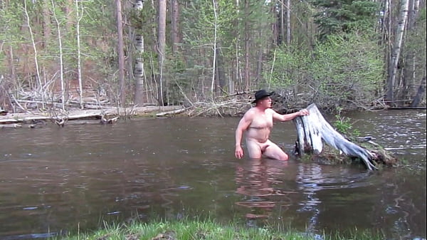 Bathing naked in the river.