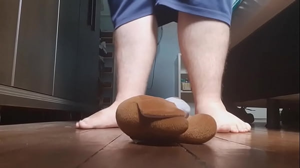 Giant feet crushing a teddy bear