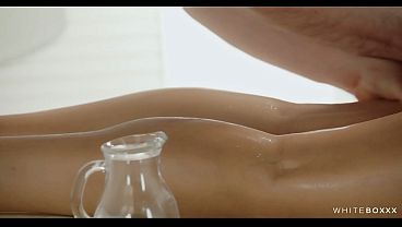 Download Video - Brunette Lies Face Down While Oil Gets Poured and Rubbed Into Every Curve