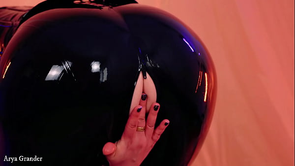 sexy curvy MILF fetish model posing in latex rubber catsuit