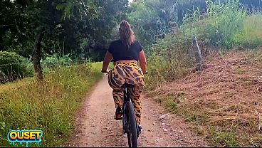 A big-assed woman in tight leggings rides a bike through the woods and ends up giving head and getting fucked outdoors with her huge ass