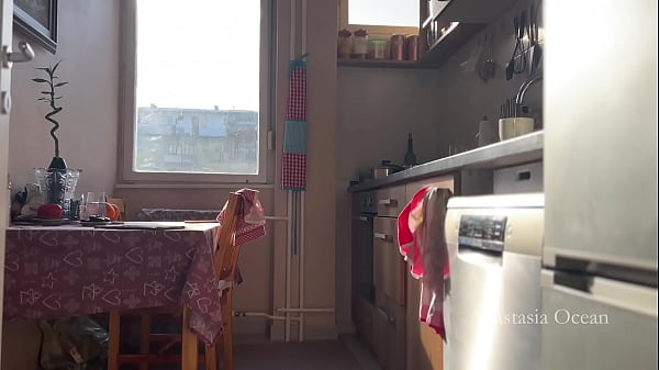 Sunny morning and she is making coffee in stokings and hills. Voyeurism.