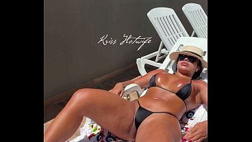 Kriss, a hot wife slut, showing off in the hotel pool with her naughty bikini, which is all tucked into her ass.