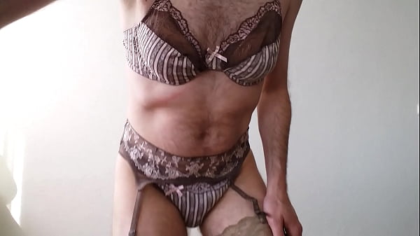 Man wearing Passionata Lingerie set and putting on a garterbelt