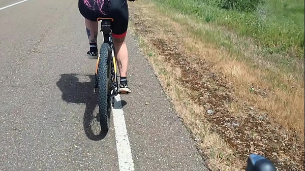 Two hot cyclists meet on the road