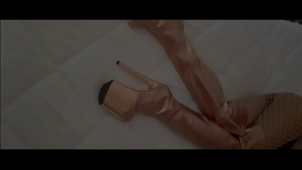 Gold knee high boots, fishnet stockings, micro skirt and a white mini top