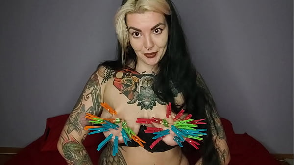 Tattooed, kinky girl hangs the maximum number of clothespins on her big tits