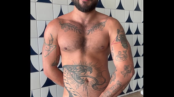 Tattooed guy jerking off until he ejaculates.