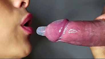 Close-up of a wet blowjob with a condom&period; Beautiful lips warm my cock