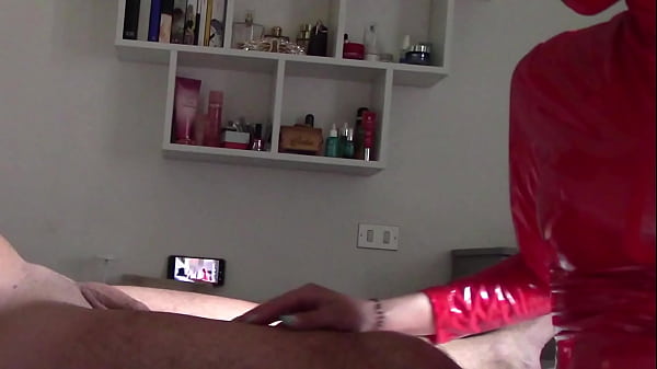 Milf in red latex suit and patent leather high heels gives a blowjob with swallow