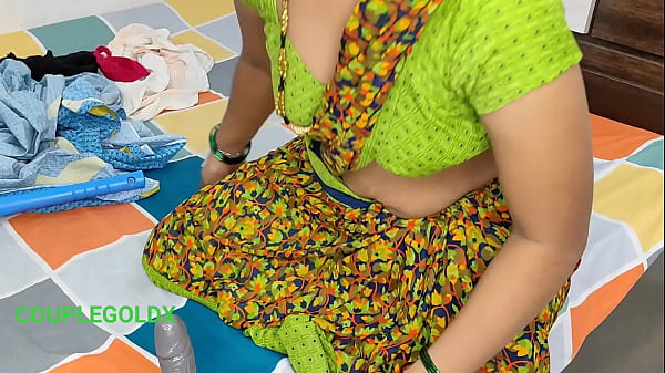 Komal's maid was sweeping and picking up the clothes on the bed.