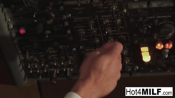 Flight attendant with big fake tits takes cock in the cockpit