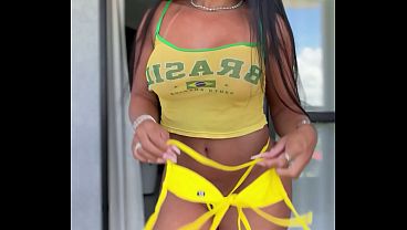Married prostitute trying on Brazilian outfits to show off during the World Cup.