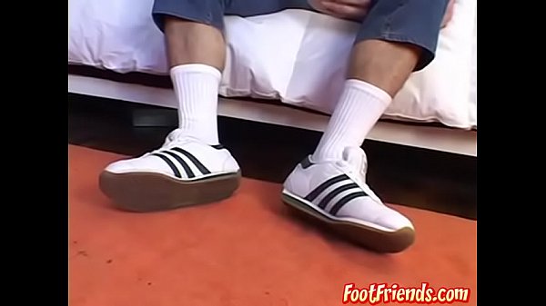 Cute stud gently playing with his feet and lick...