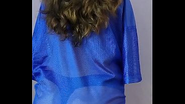 From behind, wearing a see-through shirt and thong