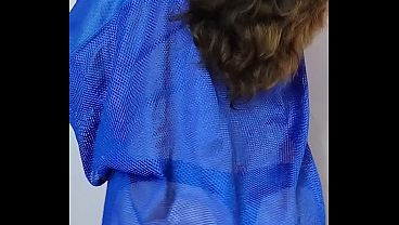 From behind, wearing a see-through shirt and thong