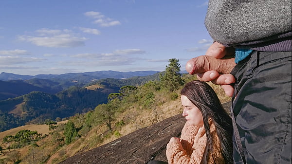 Tour guide shows stick to tourist on mountain