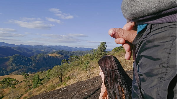 Tour guide shows stick to tourist on mountain
