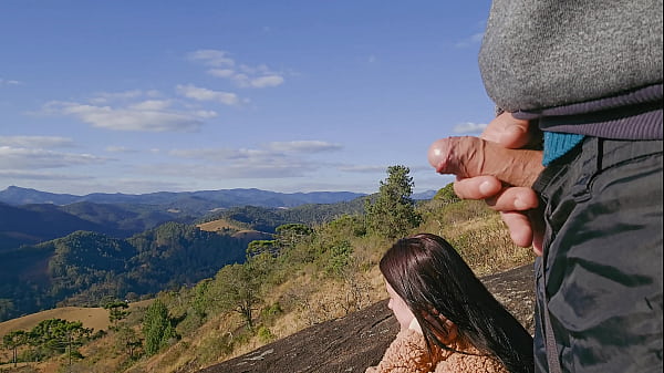 Tour guide shows stick to tourist on mountain