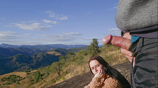 Tour guide shows stick to tourist on mountain