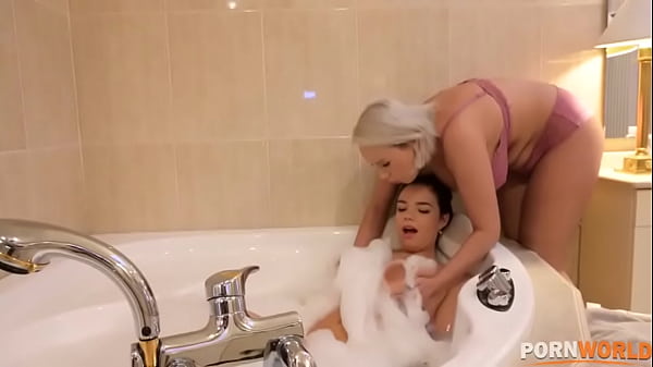 Lesbian babes Angel Wicky and Sofia Lee rub a dildo all over their big tits GP1268