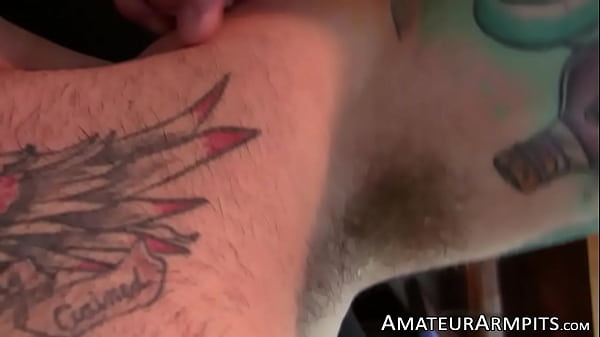 Horny inked stallion sniffs his armpits while m...