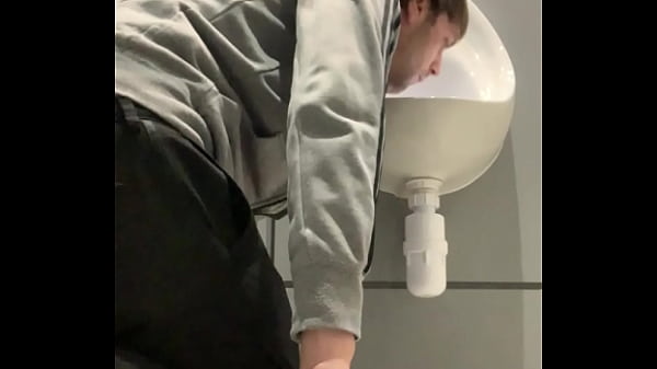 thumb drinking from t he urinal