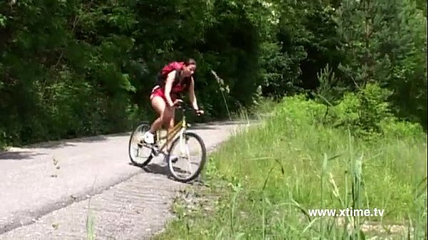 Young brunette masturbating on the grass with a dildo