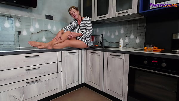 Mature Redhead Iris Showing Legs and Feet In Tan Pantyhose Tease