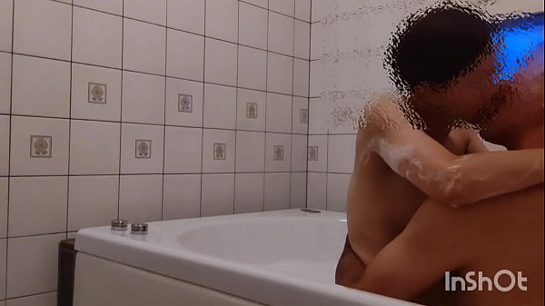 A middle-aged couple is about to take a bath when...