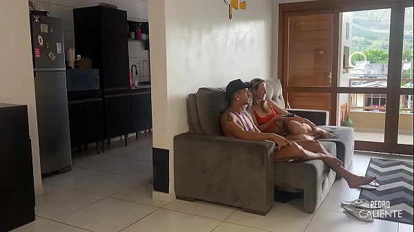 HER HUSBAND IN THE KITCHEN AND HER IN THE LIVING ROOM WITH HER FRIEND