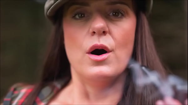 Denise Klarskov smokes a pipe and plays pussy outdoors.