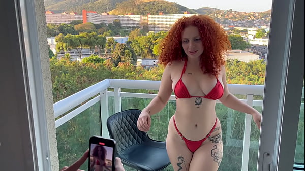 redhead model hires photographer and he ends up sucking her pussy on the balcony for neighbors to see