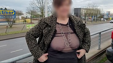 A busty milf braless with sheer top.