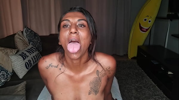 Desi sits on the couch drooling as she sticks out and wiggles her tongue around