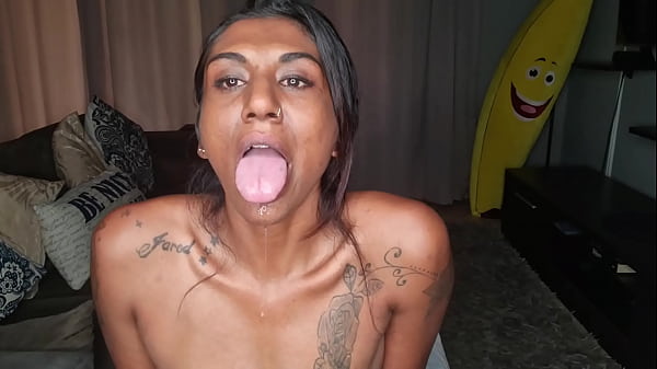 Desi sits on the couch drooling as she sticks out and wiggles her tongue around