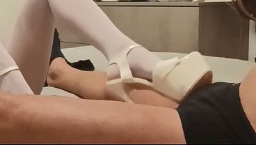 MILF in pantyhose and heels gives a footjob