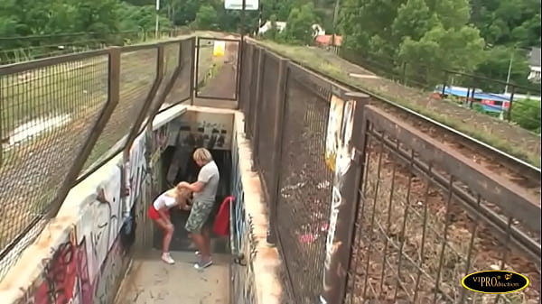 He fucks the blonde girl and cums in his mouth near the train tracks