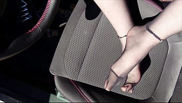 Feet of nylon boy in tights in car