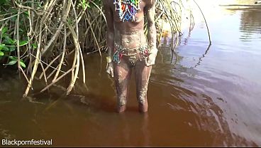 Skinny tribe girl with a body full of mud naked outdoor