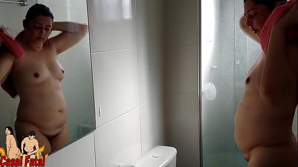 Housewife taking a shower. She stay nude after showering.