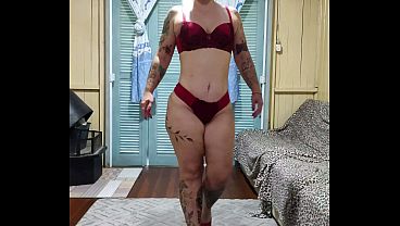 taking off her clothes, showing her breasts, ass, and hairy pussy.