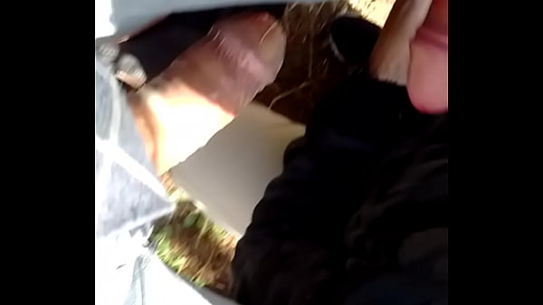 Sucking two cocks outdoors